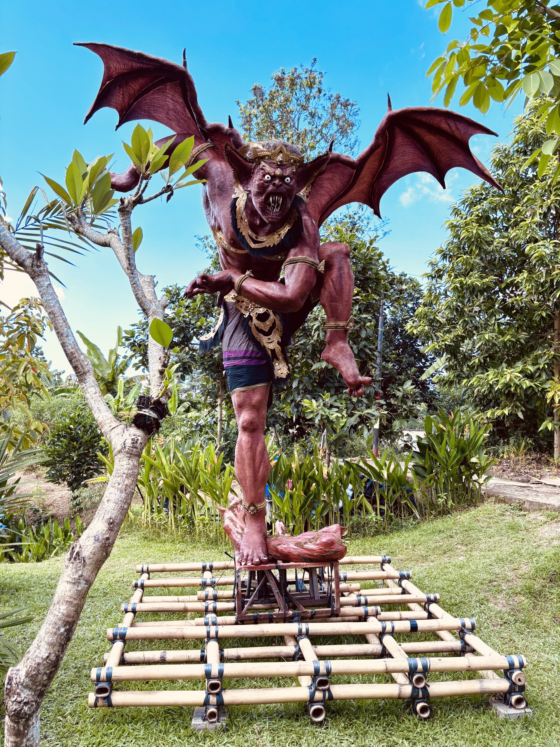 Traditional Bali statues at the entrance of Kanto Lampo waterfall