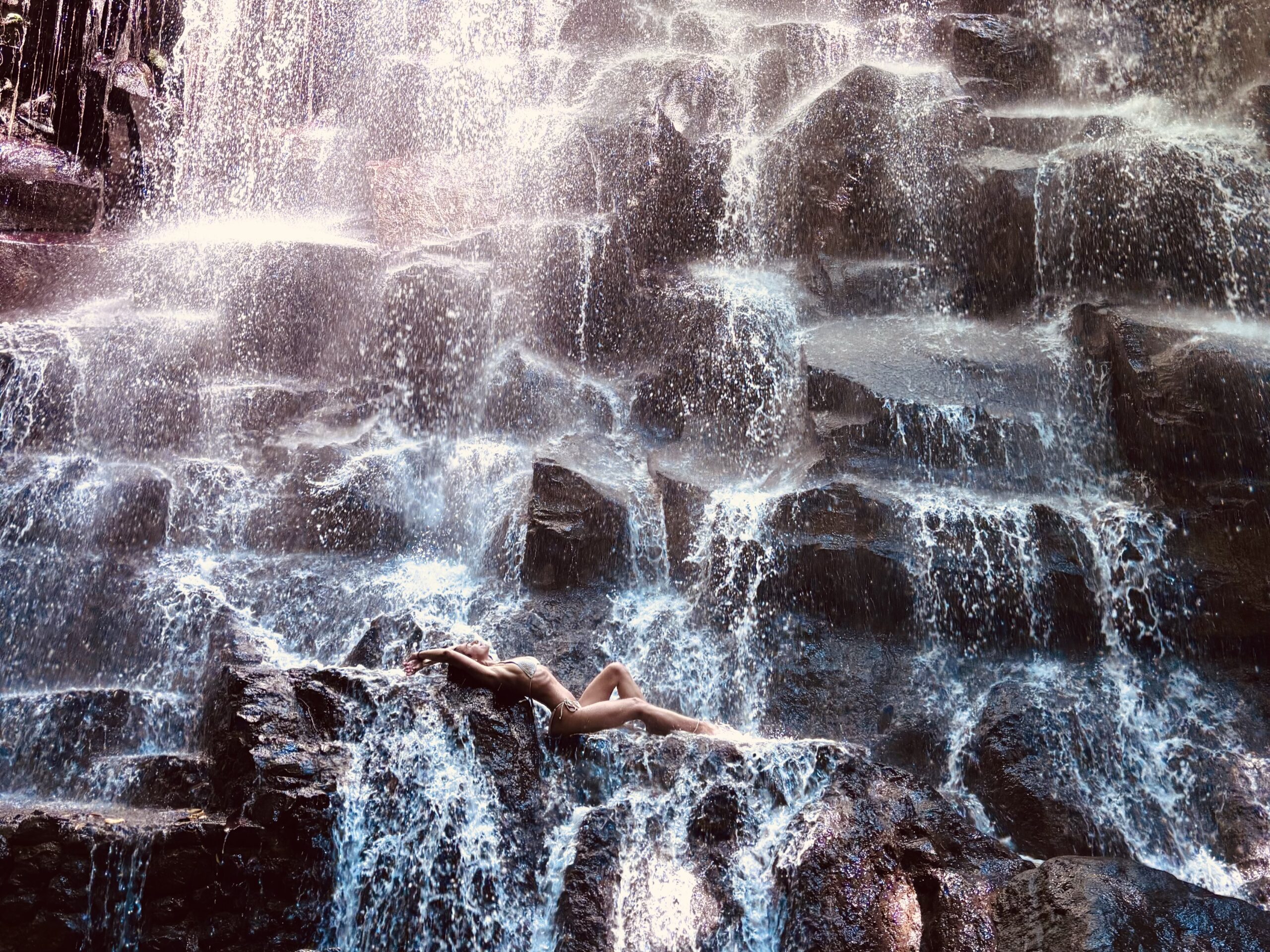 Traveler posing in front of Kanto Lampo Waterfall in Bali