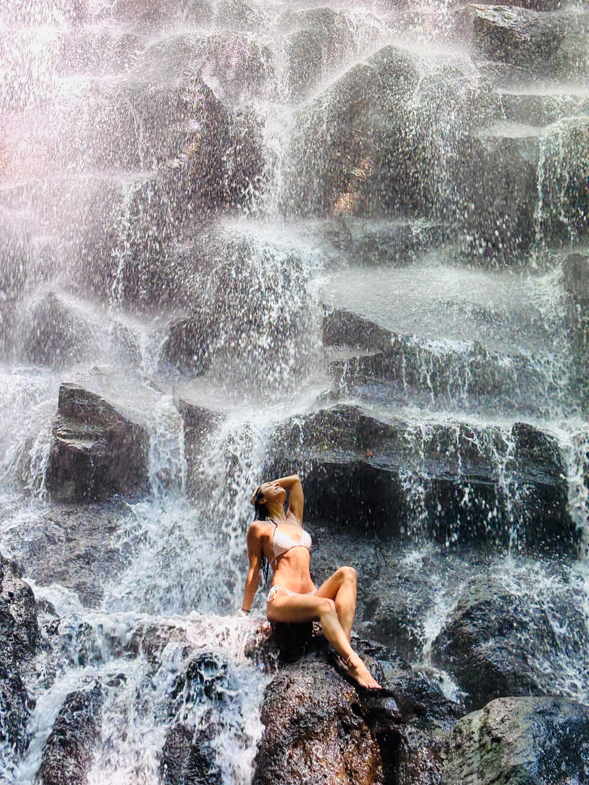 Traveler posing in front of Kanto Lampo Waterfall in Bali
