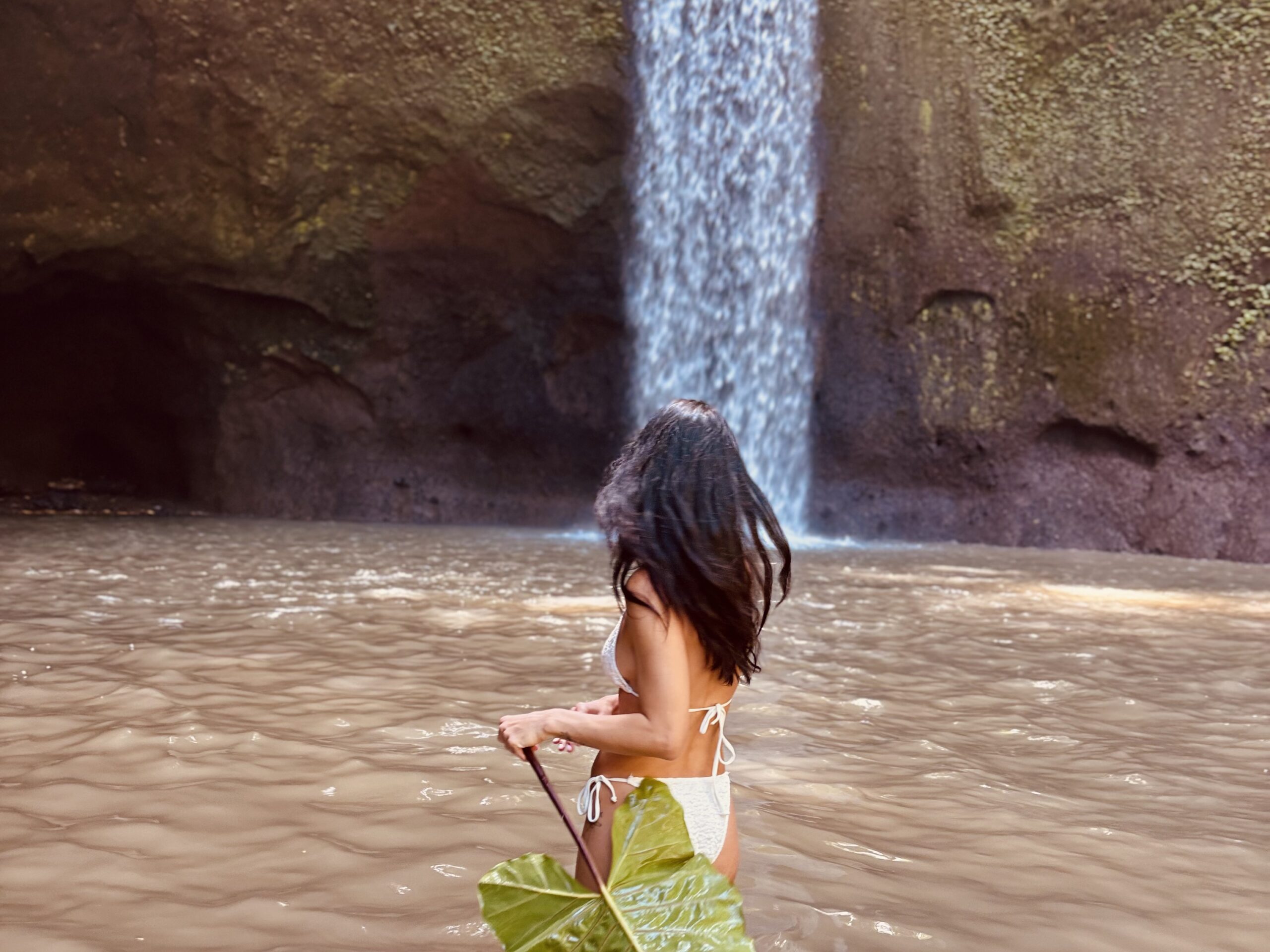 Me standing in front of Tibumana Waterfall in Bali, enjoying the peaceful natural surroundings.