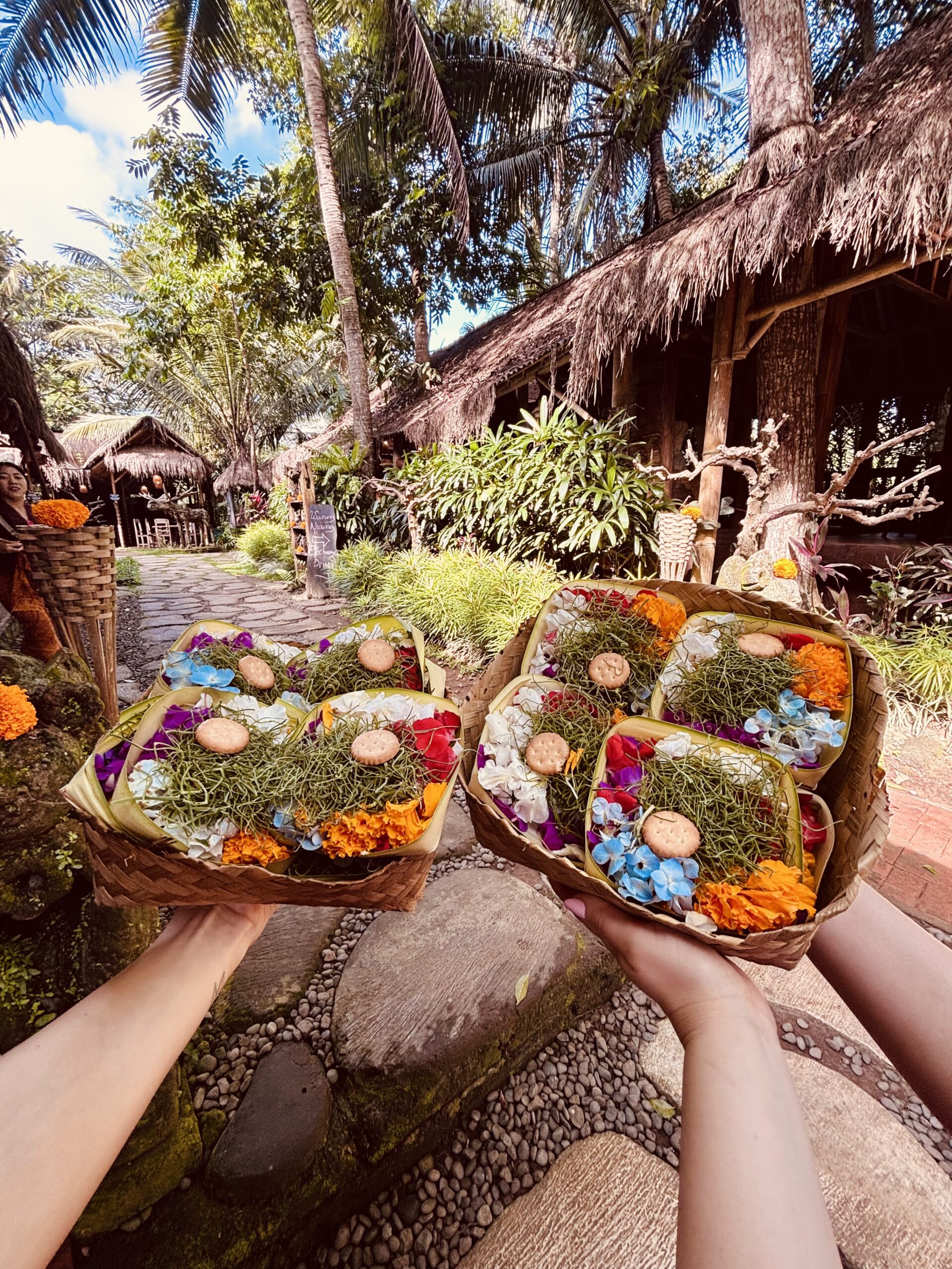 Little bamboo trays, called canang sari, filled with flowers, rice, incense, and sometimes candy or crackers. They’re a way of showing gratitude to the gods and maintaining harmony